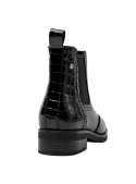 Botín Chelsea negro de cuero para mujer con costuras brogue y paneles elásticos para un calce cómodo.