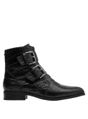 Botín negro de cuero para mujer, ideal para uso urbano, con taco bajo y diseño estilizado y moderno.
