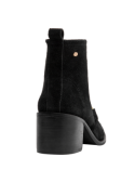 Botín casual de cuero negro para mujer, detalle artesanal en costuras y hebilla, versátil para diversas ocasiones.