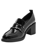 Detalle de hebilla en zapato formal de cuero charolado negro para mujer.