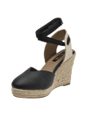 Alpargata de cuero negro para mujer con plataforma de yute y cintas al tobillo.