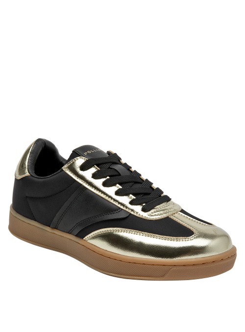 silueta moderna de zapatilla negra con acentos dorados brillantes y suela color caramelo