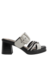 Sandalia de cuero blanco combinada con atuendos versátiles para un look casual y moderno.