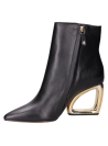 Calzado elegante negro, botines de cuero para mujer, ideal para combinar con vestidos.