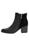 Botín negro de cuero para mujer, diseño vanguardista, ideal para elevar vestidos fluidos.