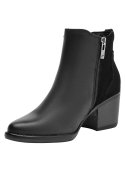 Botín negro de cuero para mujer, estilo casual, ideal para combinar con jeans ajustados.