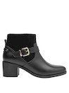 Enfoque en el tacón bloque de 5 cm del botín negro de cuero para mujer, combinando elegancia y comodidad.